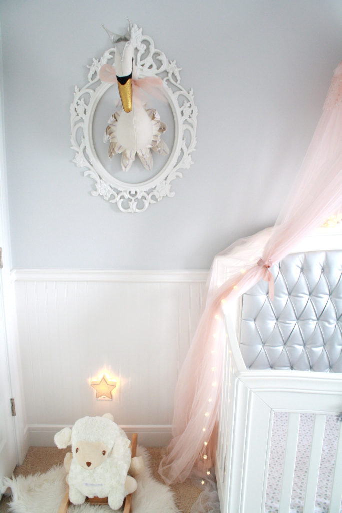 Pink and gray nursery with swan head taxidermy