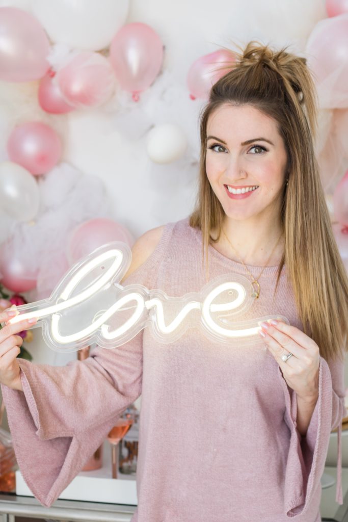 Neon 'love' sign with Chandeliers and Champagne blogger Holly Hunka 