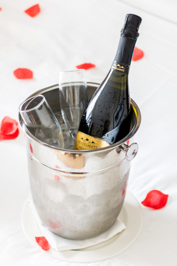 Chilled prosecco on ice in ice bucket with champagne flutes - Chateau Lacombe Hotel Edmonton Staycation