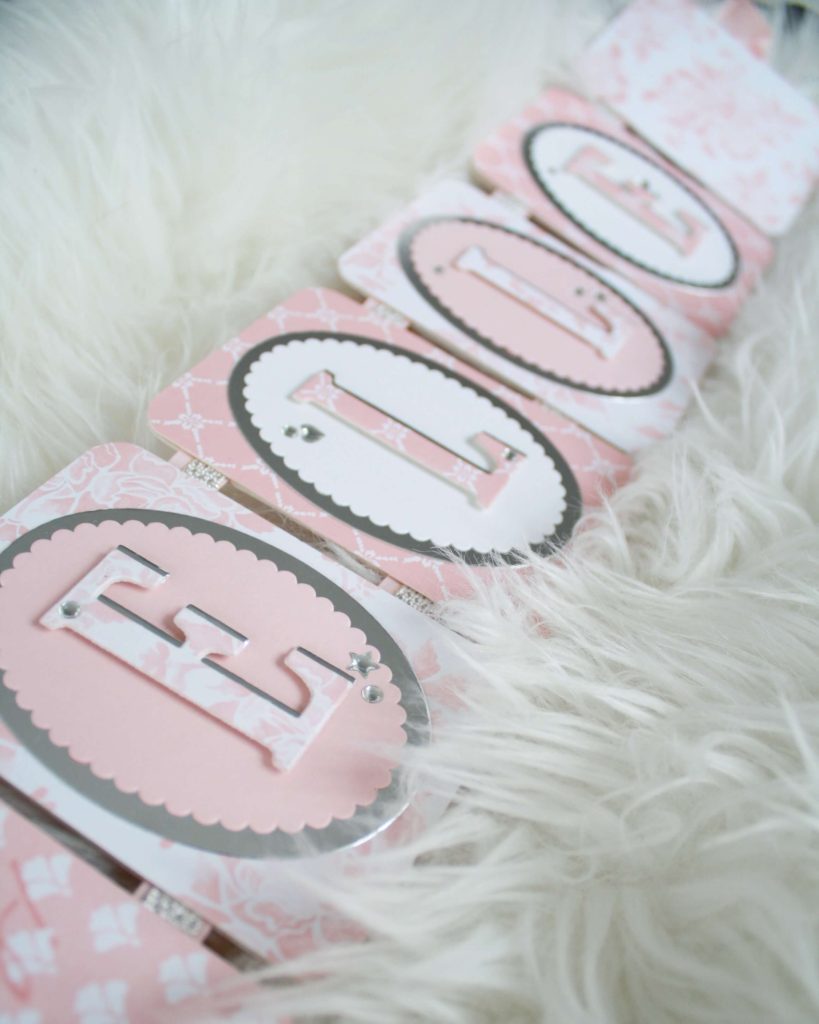 Handmade name banner in pink and white yardstick