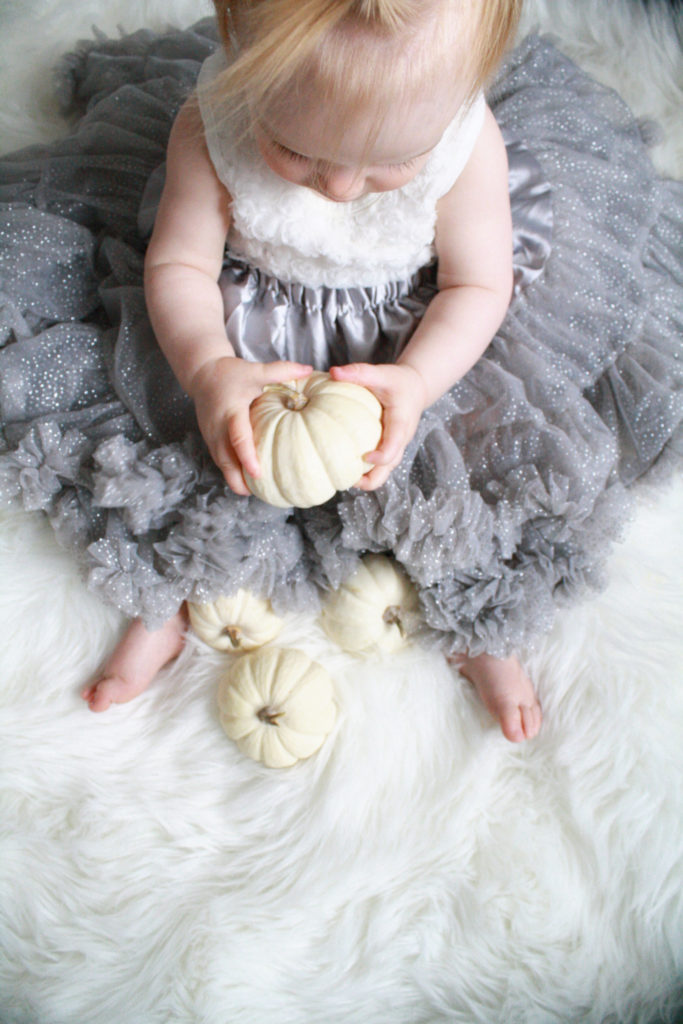 Kids and pumpkins - fall baby photography - Easy fall toddler photo idea using mini white pumpkins - Toddler fall photoshoots with pumpkins - Toddler girl in tutu with white pumpkins