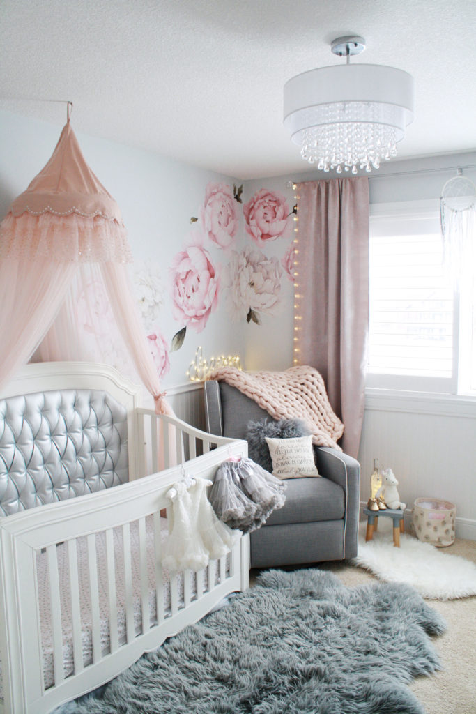 Baby girl pink and gray nursery with chandelier, tufted crib, pink crib canopy and peony wall decals 