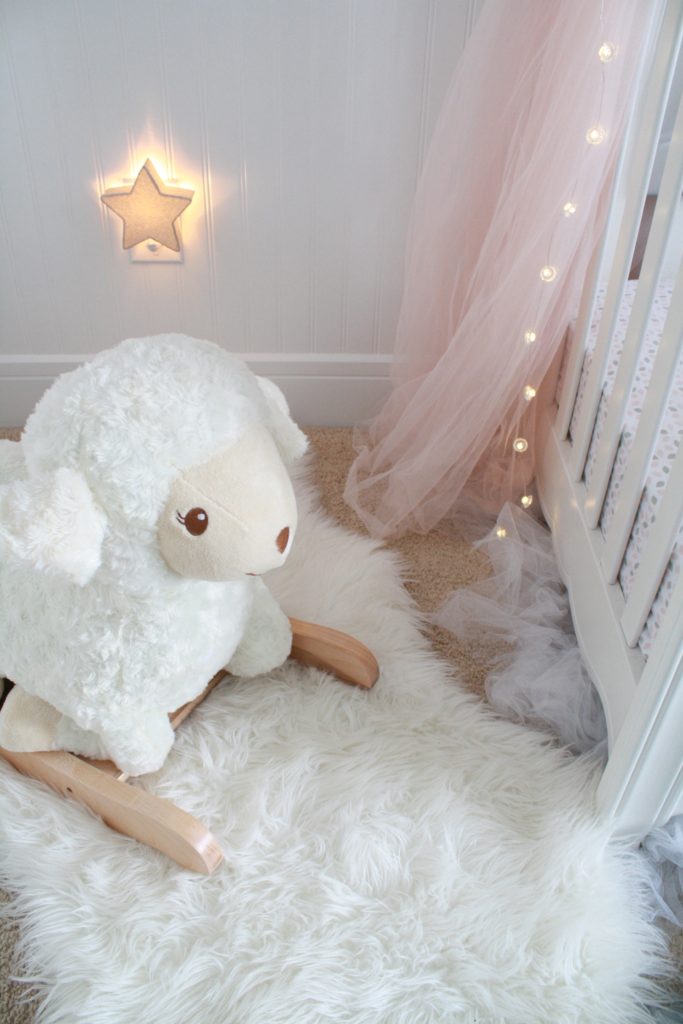 Pink and gray nursery with rocking lamb and star light