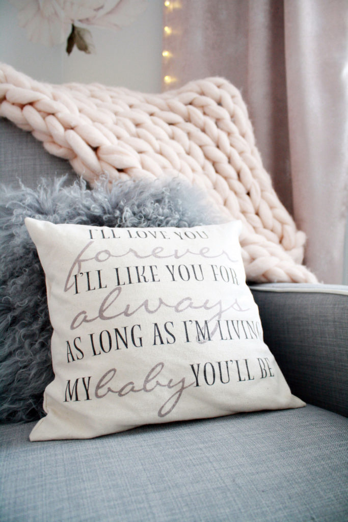Pink and gray nursery with 'I'll love you forever' pillow