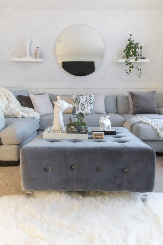 Loving the velvet gray ottoman in this light and bright kid-friendly living room w