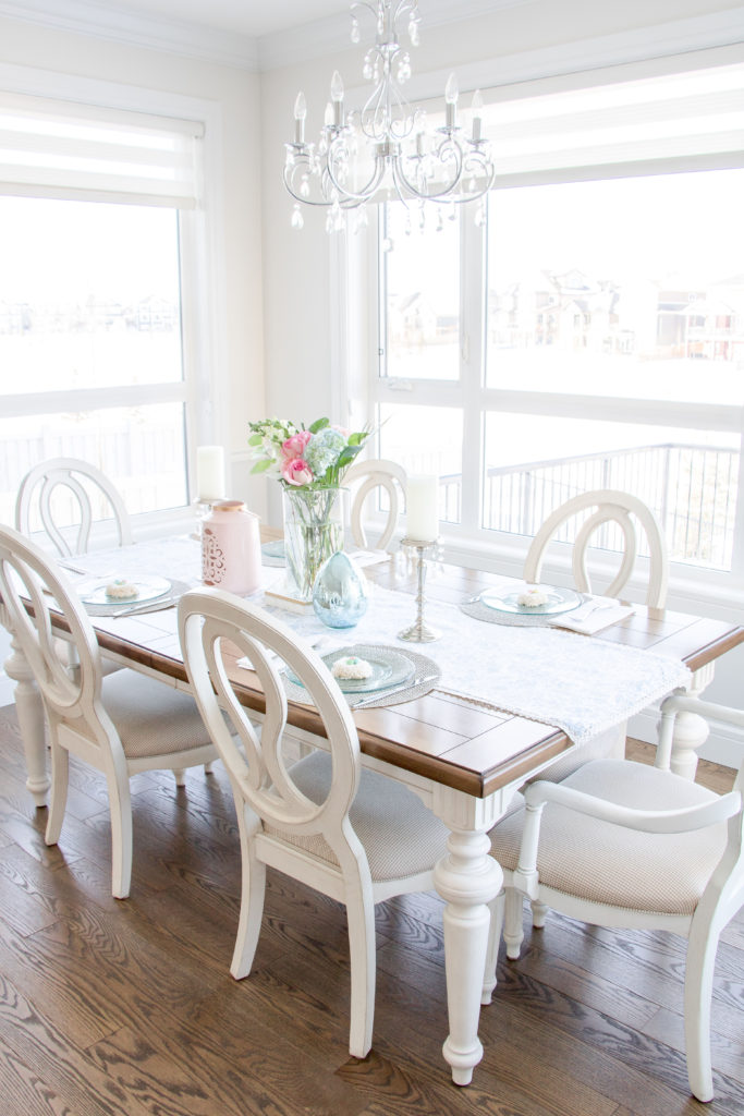 Refresh for spring with a new tablescape. Natural lighting, a chandelier, fresh florals and pastel accents make this space pop
