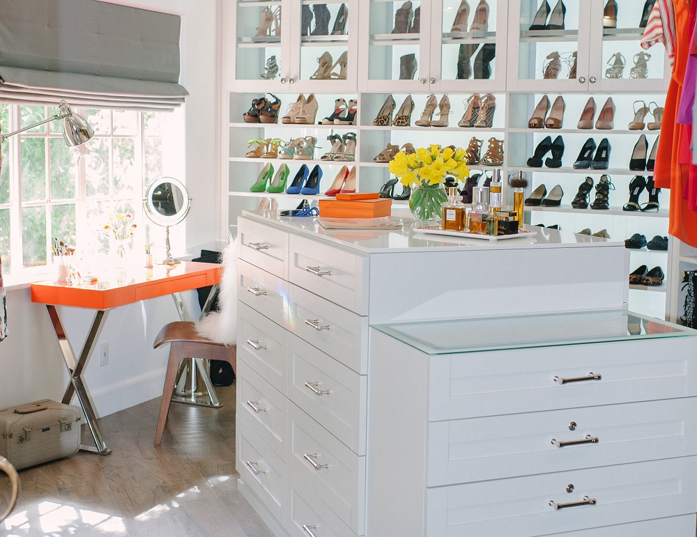 Dream walk-in closet with back-lit shoe displays and white cabinets. Stunning celebrity walk-in closets. Closet organization. Luxury homes.