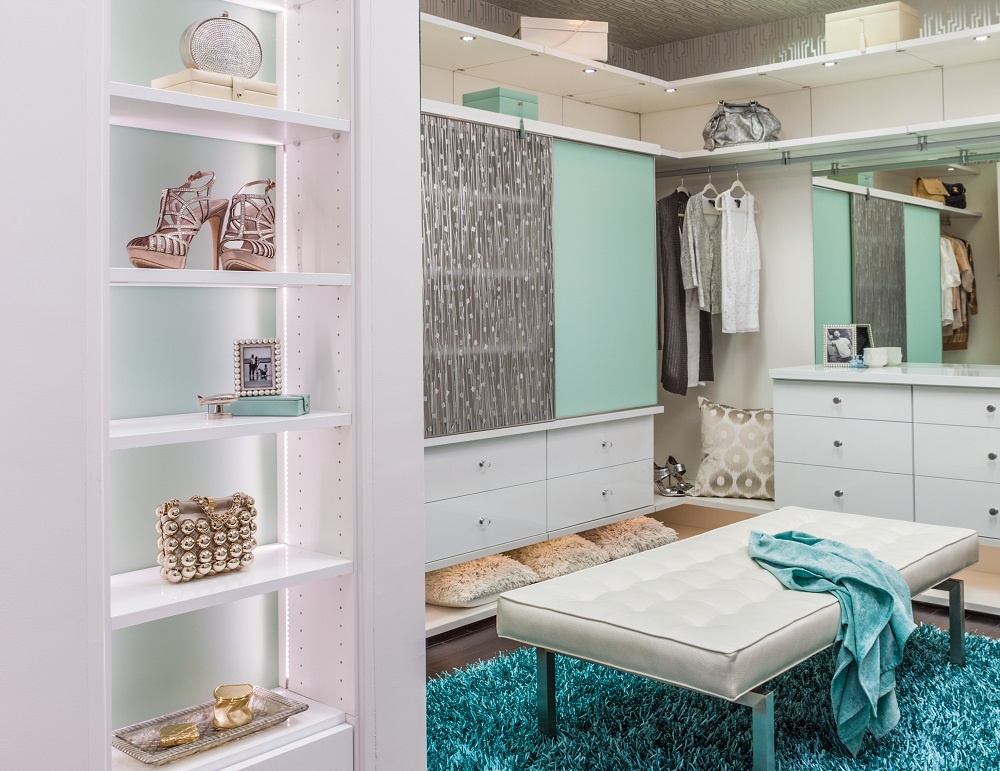 Luxury bedroom walk-in closet dressing room in white and aqua tones. Luxury homes and organized spaces.