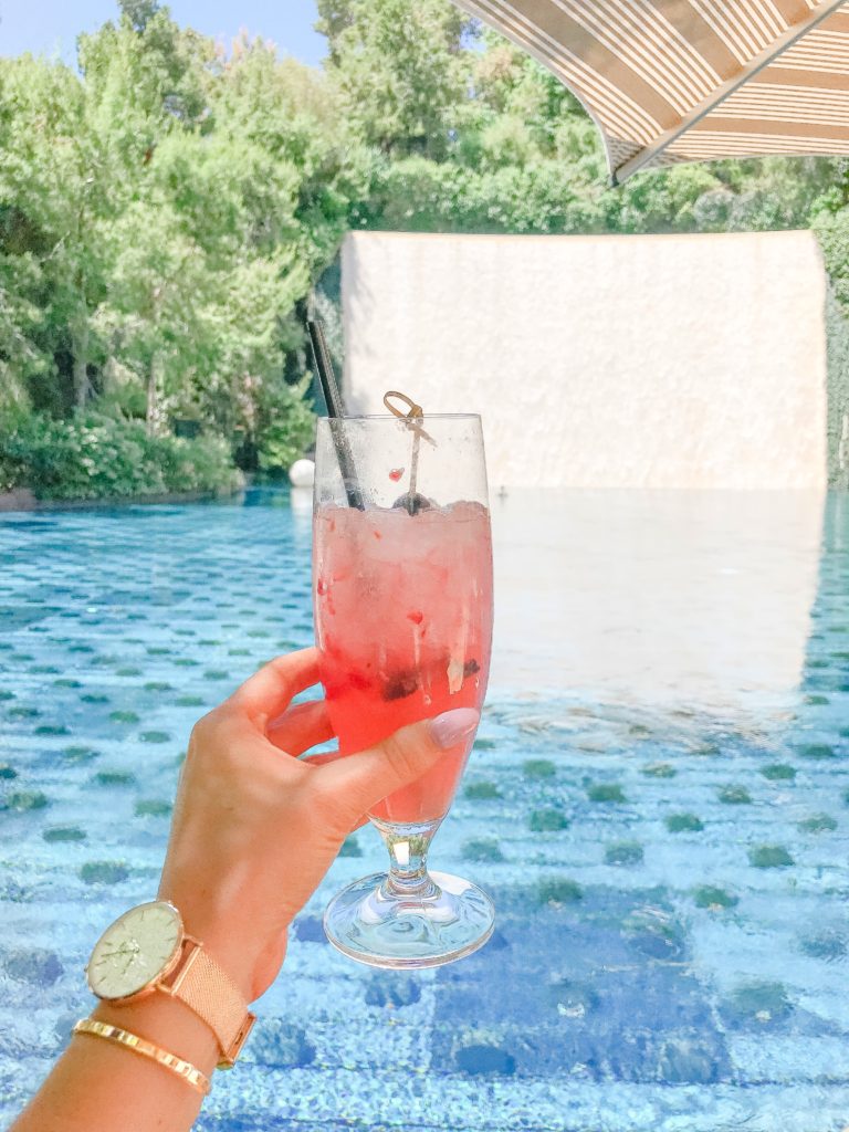 Enjoying a cocktail at Wynn’s Parasol Down. It’s hard to beat enjoying a tasty beverage amid a 40-foot waterfall and the Lake of Dreams. Las Vegas Travel Tips.