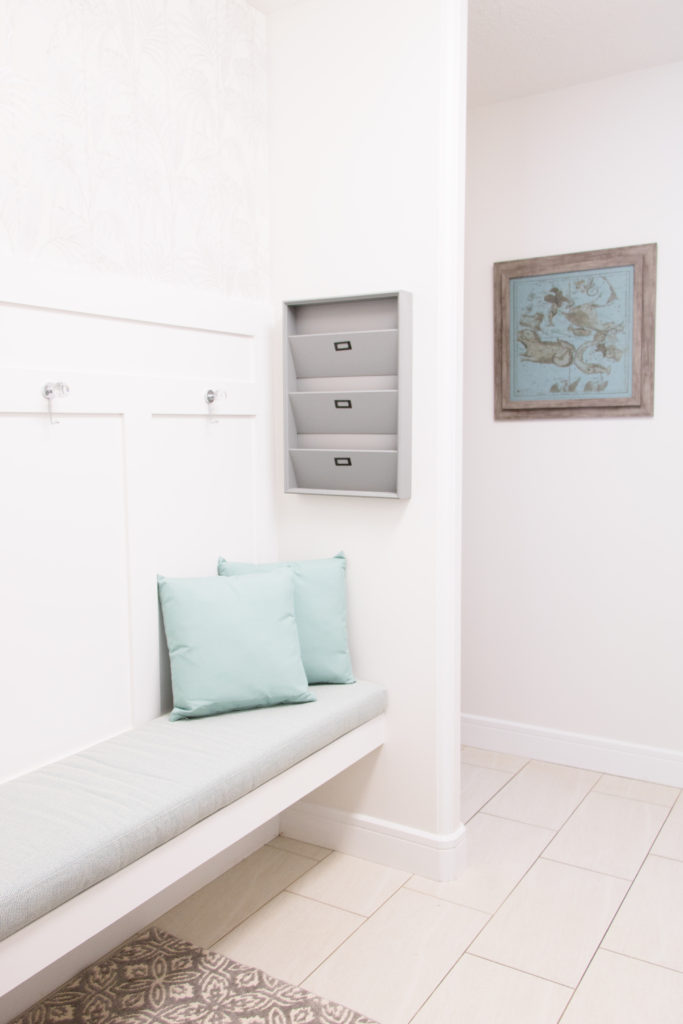 Bright white mudroom refresh • Mudroom design ideas • White and teal mudroom with custom bench and wainscoting 