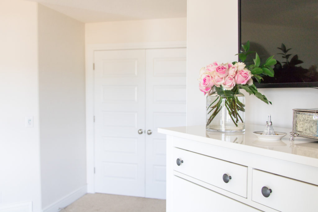 White unit with pink roses in a bright and cozy master bedroom - gray, white and pink bedroom ideas