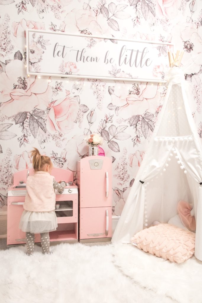 Glamorous pink playroom with white floral wallpaper, a white lace teepee, and pink kids play kitchen - GIrly nursery design ideas - Girly playroom design ideas
