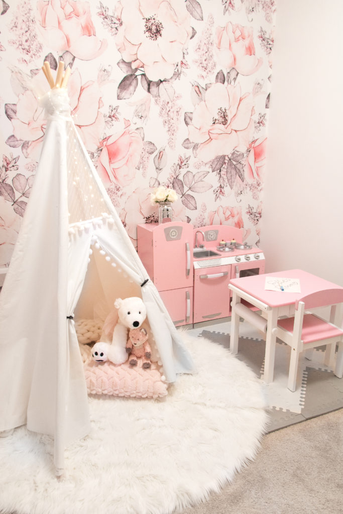 Glamorous pink playroom with white lace teepee, pink play kitchen and floral wallpaper - Floral wallpaper nursery ideas - Playroom ideas for girls