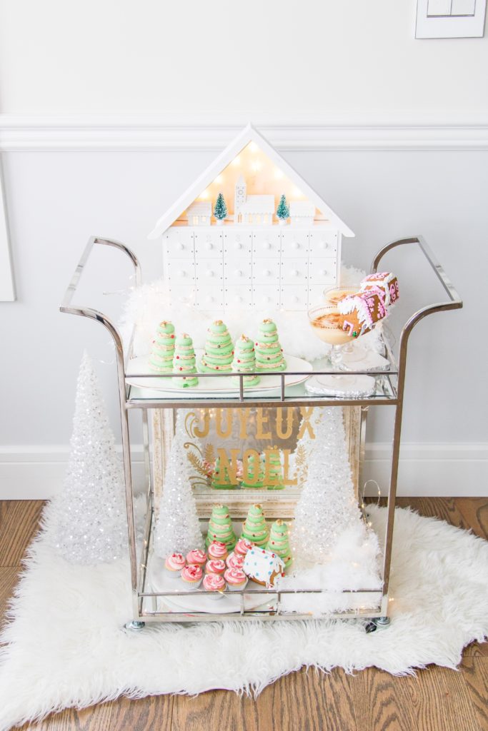 Christmas Dessert Bar Cart with house and white fluffy snow made from feather dusters, Christmas bar cart styling ideas