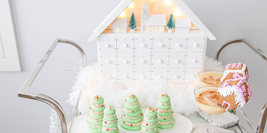 Christmas Dessert bar cart with white decor, advent calendar, macaron Christmas trees, gingerbread cup toppers and candy cane cupcakes