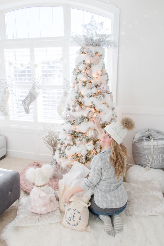 Setting up gifts in front of snowy white feather Christmas tree, Swoon-worthy Christmas Gift Guide, Christmas 2018 gift giving ideas 