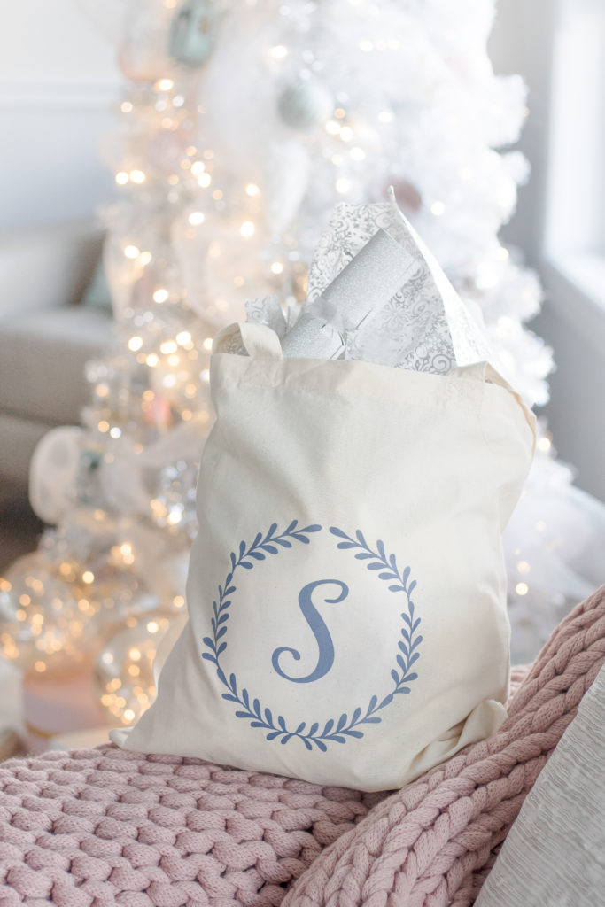 Monogramed tote bag for swoon-worthy Christmas gift wrapping ideas, Christmas present wrapping, white and pink Christmas gift wrap, reusable gift bags