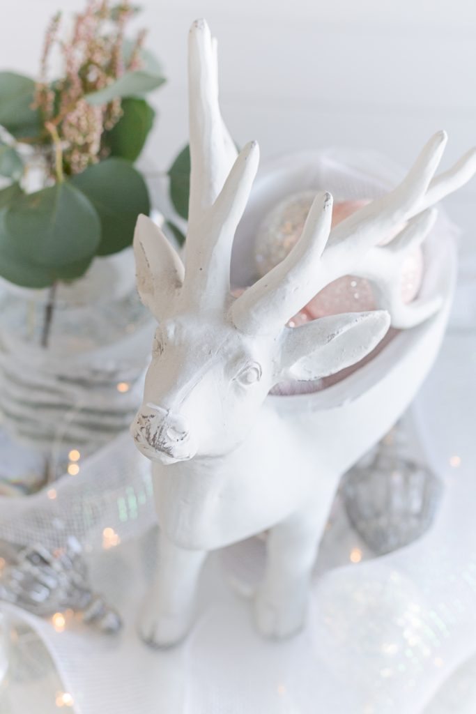 White reindeer coffee table Christmas decor with pastel Christmas ornaments, white Christmas coffee table decor, pink Christmas coffee table decor