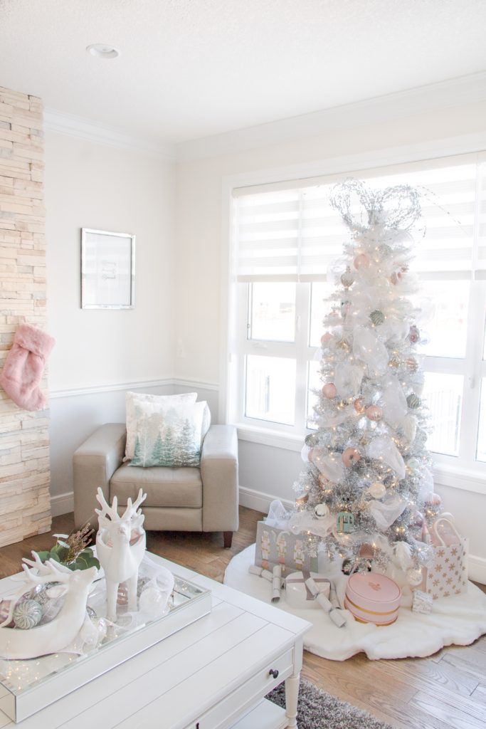 White ombre and silver Christmas tree with blue and pink pastel Christmas decor and ornaments, light bright Christmas decorating ideas