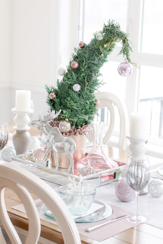 Glamorous and feminine Christmas tablescape featuring pastel decor and adorable Grinch tree centerpiece