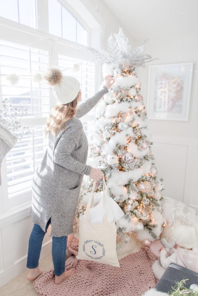 Decorating blush pink and white snowy Christmas tree, pink chunky knit throw, swoon-worthy Christmas gift ideas and decor