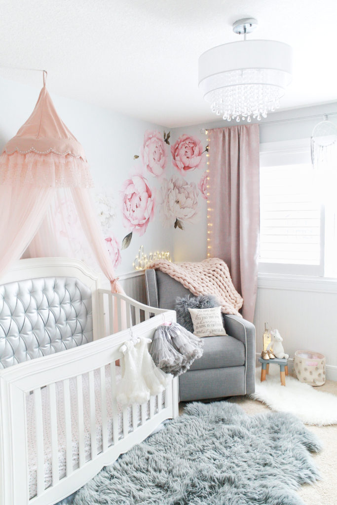 Charming gray, pink and white baby girl nursery with pink peony wall decals, pink tulle canopy and silver crib - Baby girl nursery inspiration