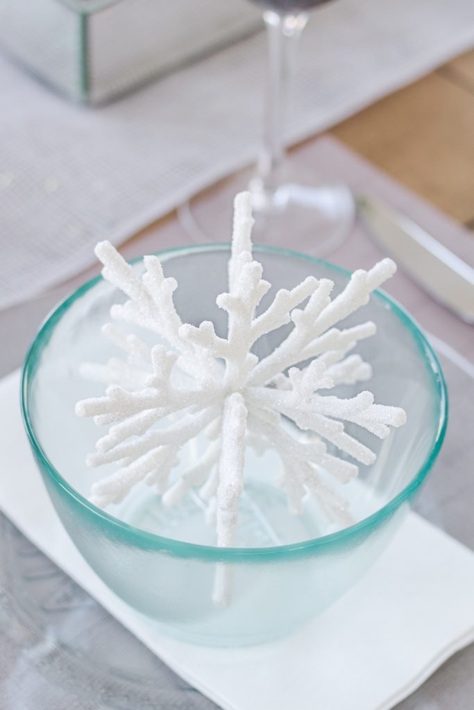 White snowflake ornament in bowl as part of charming Christmas tablescape, Christmas table setting ideas