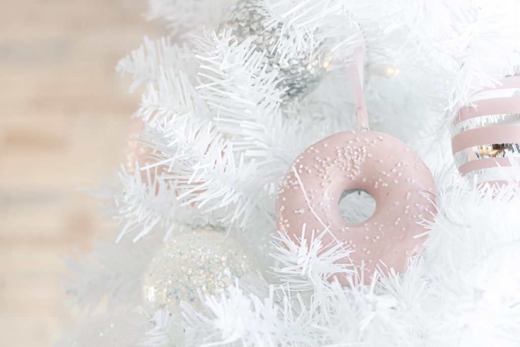 Pink donut Christmas ornament on white Christmas tree from Urban Barn
