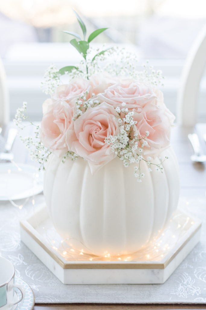 Thanksgiving pumpkin centerpiece idea using white craft pumpkin and fresh pink roses - Dreamy Thanksgiving table settings - Autumn tablescape ideas - Blush pink rose and aqua fall tablescape