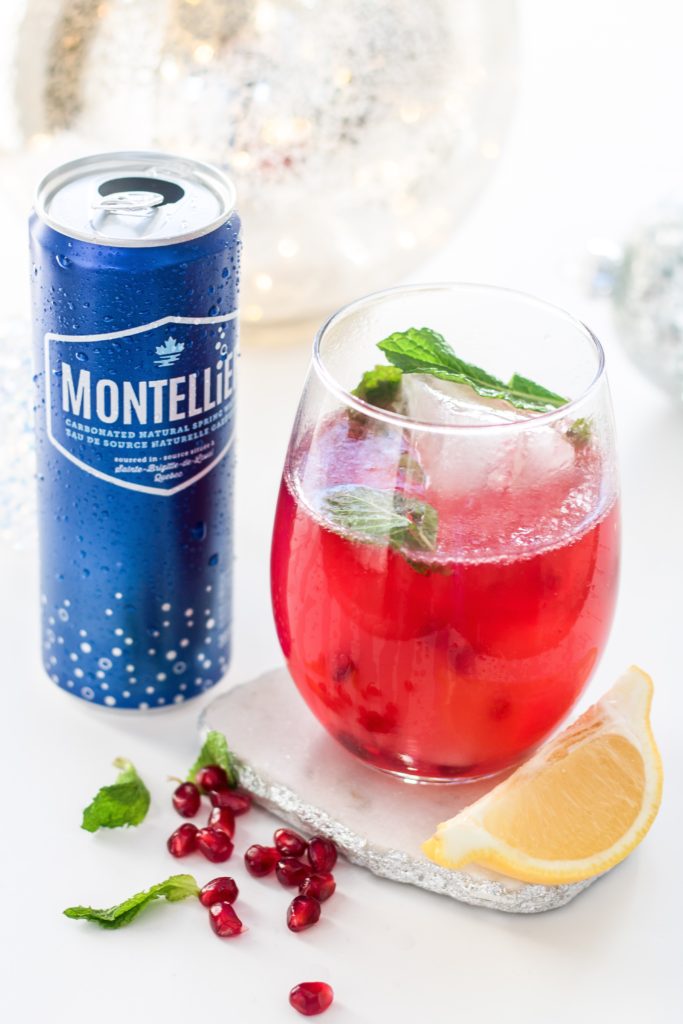 Festive Pomegranate Sparkler cocktail: white rum holiday cocktail with sparkling water, lemon juice, pomegranate juice and mint 