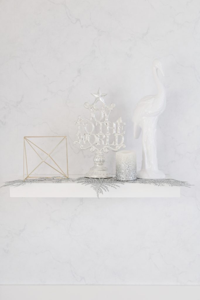 White shelf Christmas decor and marble wallpaper