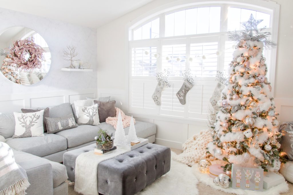 White feathered fluffy Christmas tree with pastel ornaments and light and bright living room Christmas decor