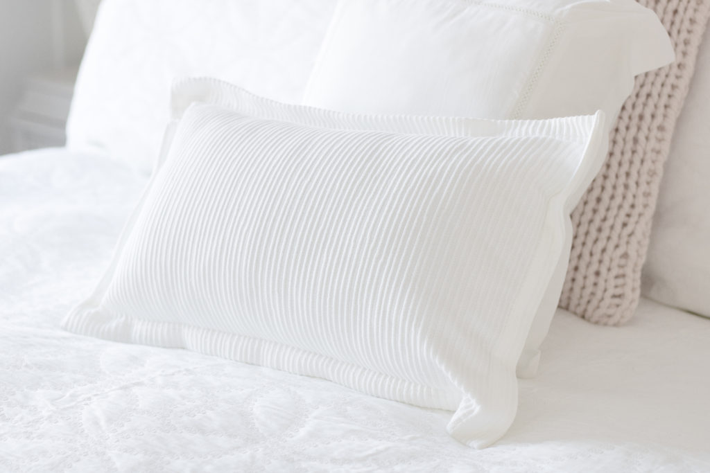 Classic white bedding accent pillows by GlucksteinHome add a relaxing element to my bedroom