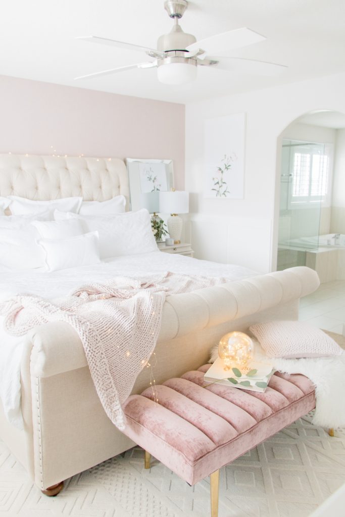 Neutral luxurious master bedroom with white bedding, neutral sleigh bed, blush pink wallpaper and velvet bench: Feminine Master bedroom design ideas 