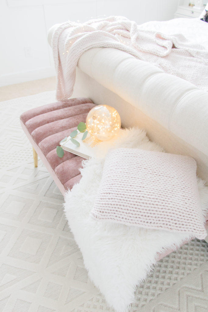 This pink chunky knit pillow and pink chunky knit throw add some feminine elegance to this neutral master bedroom