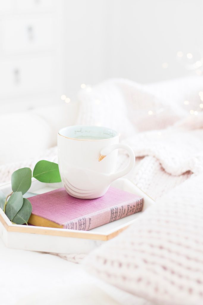 This swan mug is the cutest way to drink your morning coffee amidst classic white bedding and textured blankets