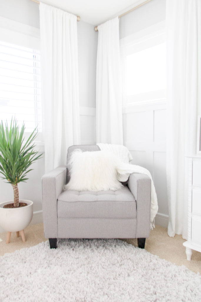 Light and airy grey gender-neutral nursery inspiration - Relaxing and cozy nursery feeding chair