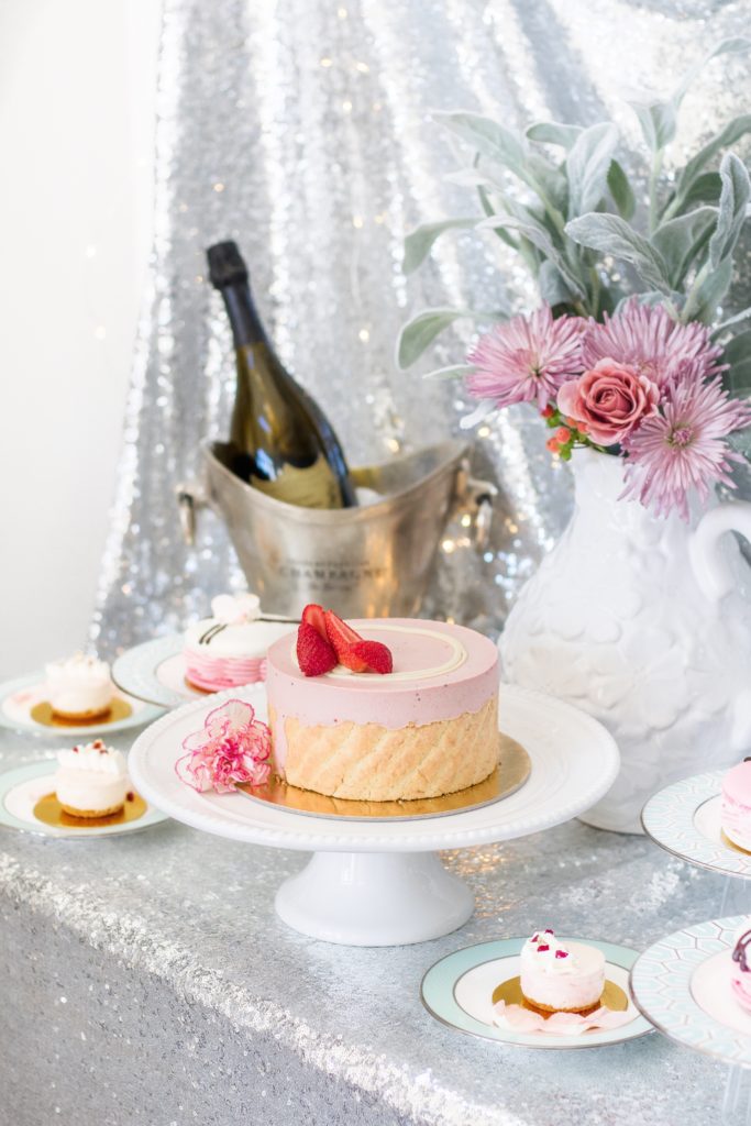 Easy Valentine's Day dessert table with pretty pink desserts, champagne and a sparkly table cloth