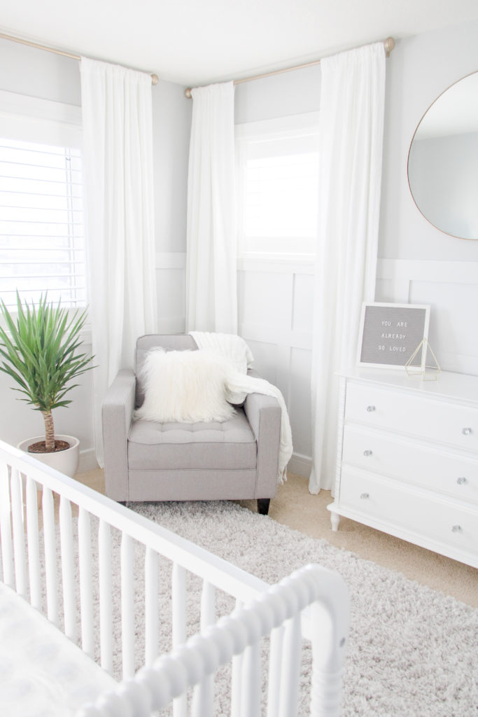 White and Grey Gender-Neutral Nursery, White and Gray Gender-Neutral Nursery with white drapes, soft gray feeding chair and gold accents 