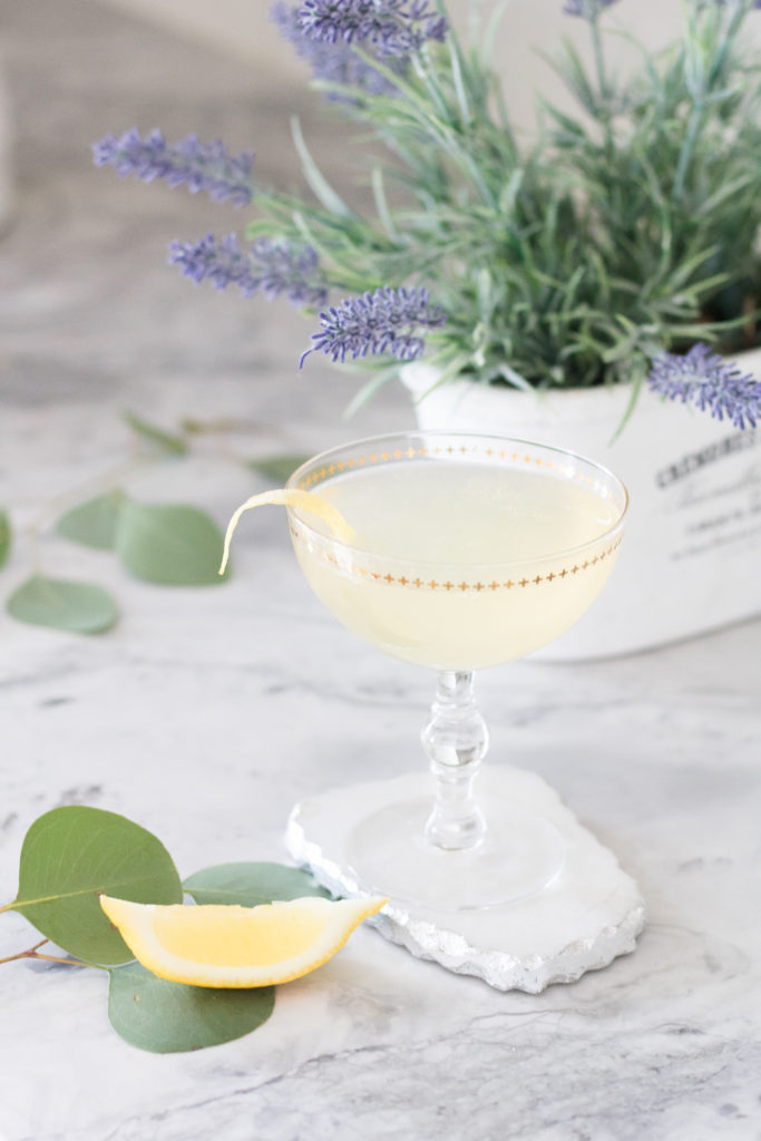 Closeup of Elderflower French 75 cocktail with lavender and eucalyptus
