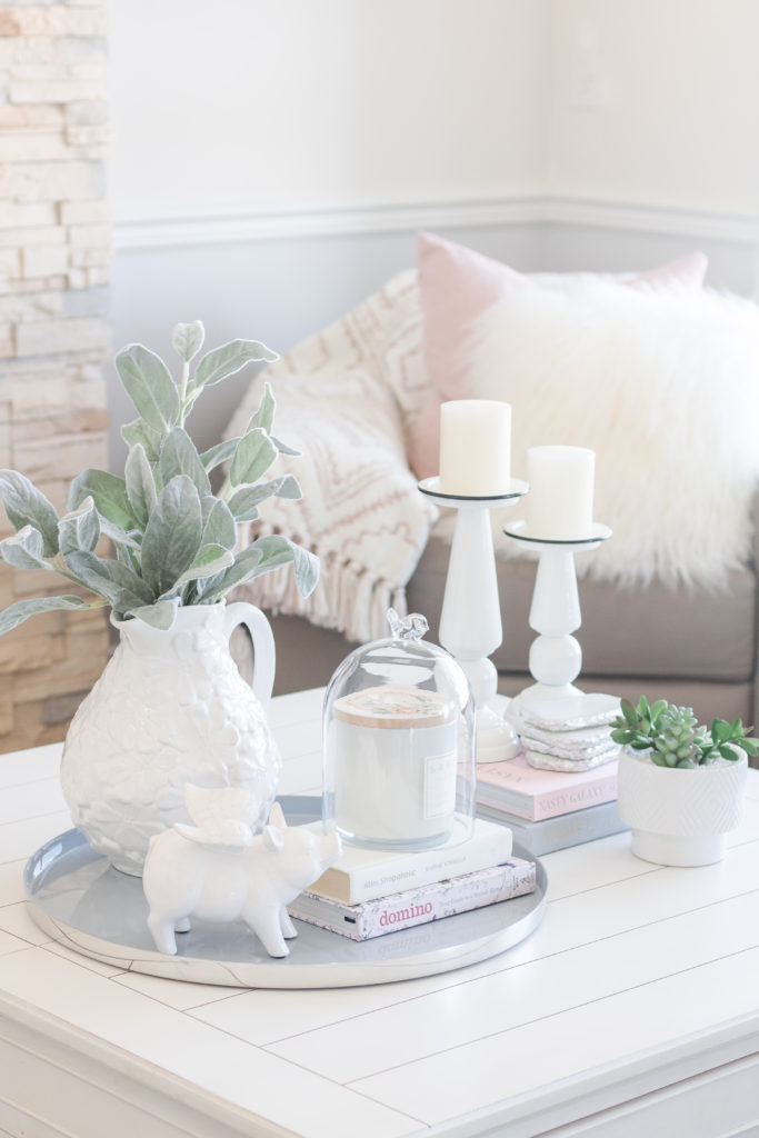 Pastel Living Room Decor for Spring: Blush pink velvet bench and white coffee table decor