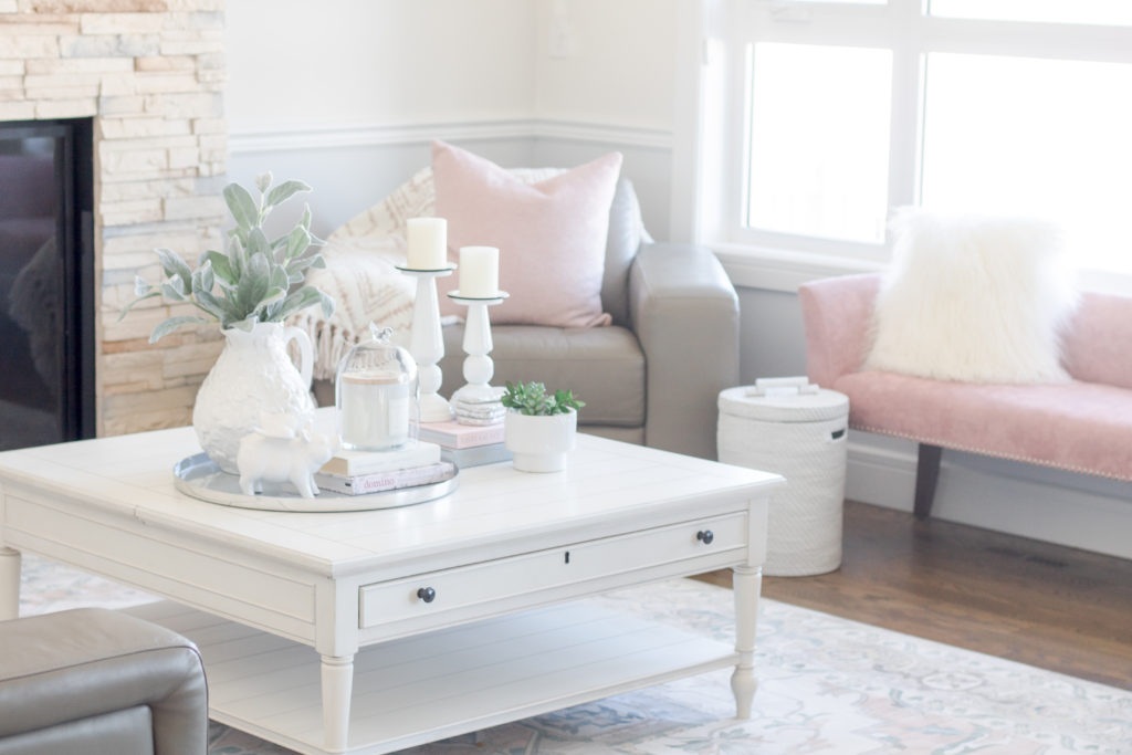 Pastel Living Room Decor for Spring: Blush pink velvet bench and white coffee table decor