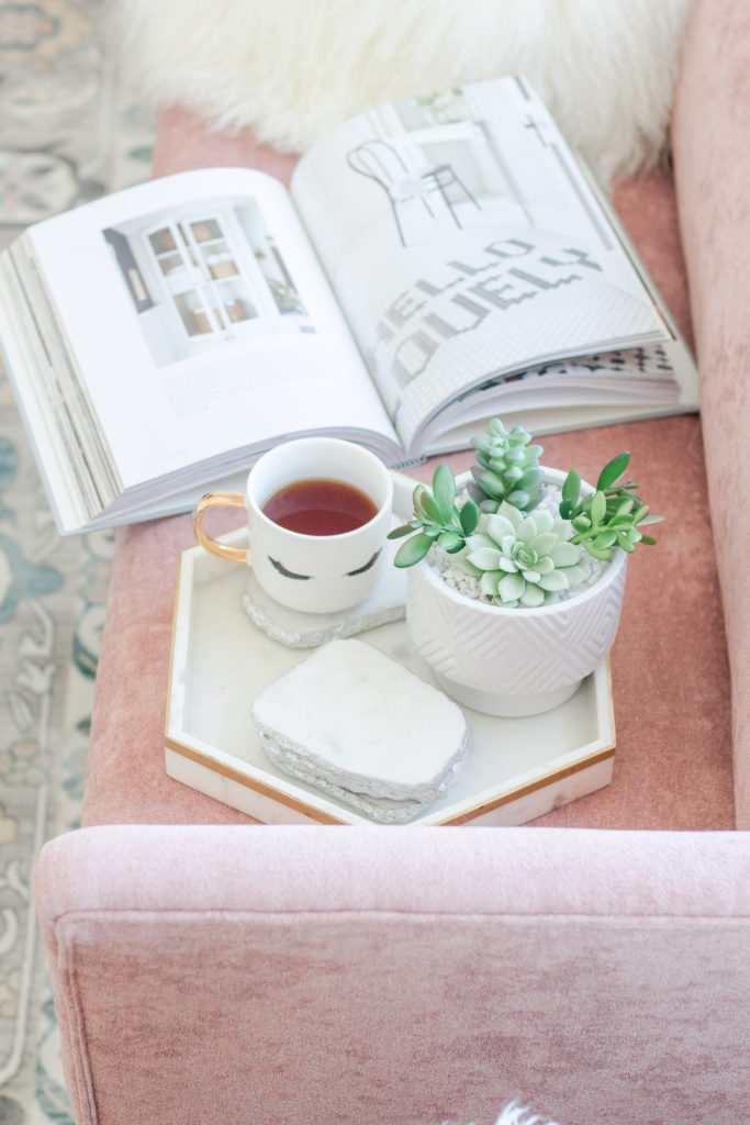 Blush pink velvet bench is the perfect spot to enjoy a coffee and book: Pastel Living Room Decor