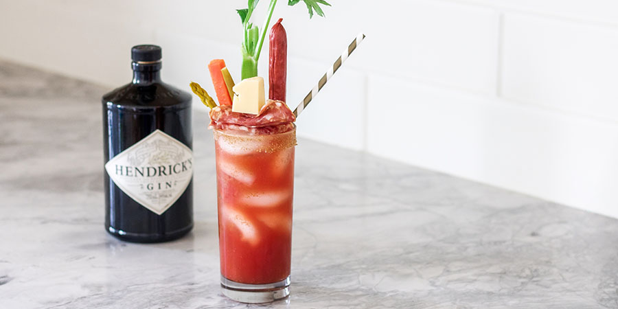Large gin caesar made with Hendrick's gin on a kitchen counter