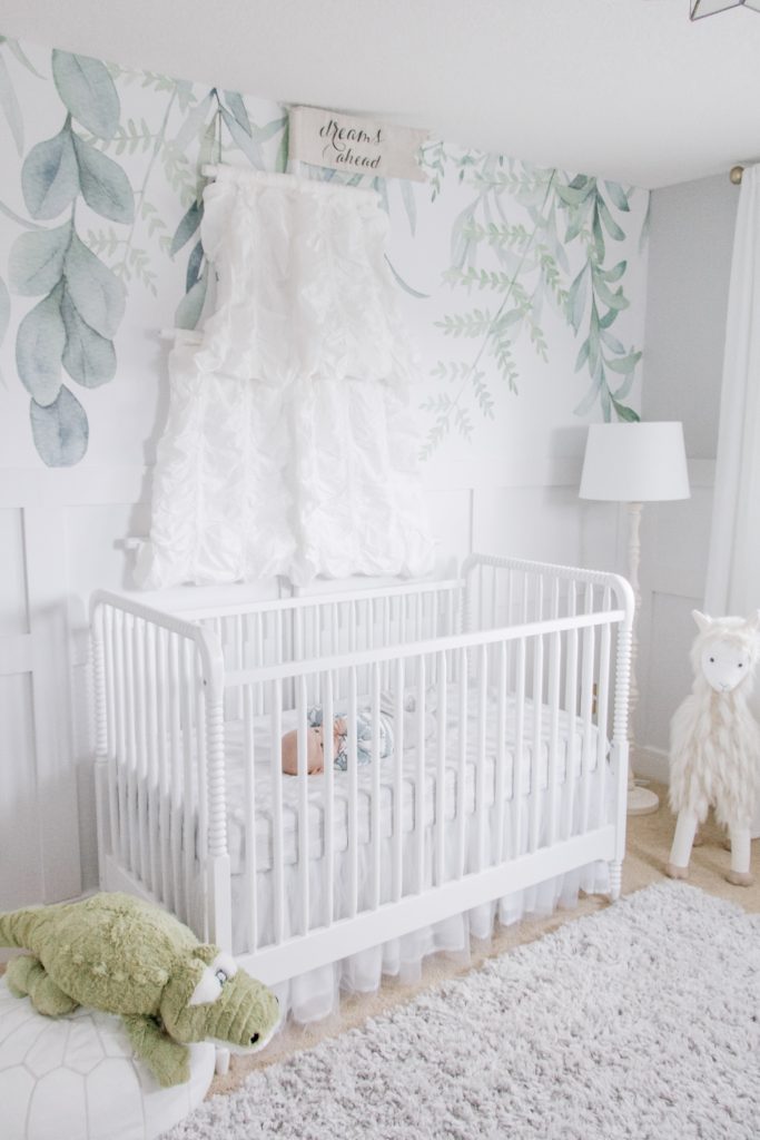 Dreamy nursery with watercolor vine wallpaper and sail canopy