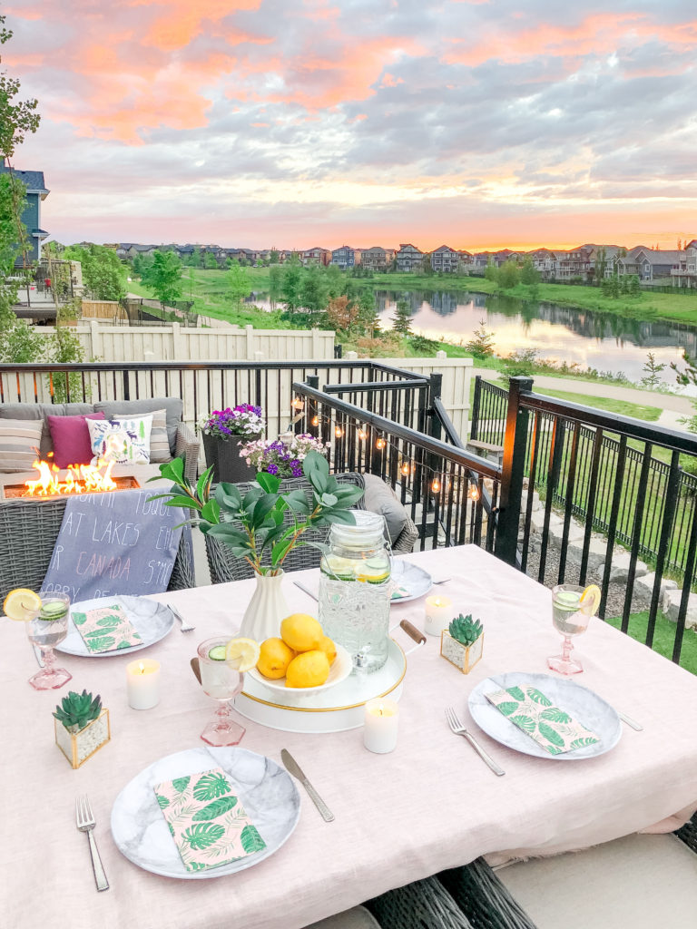 Easy Outdoor Table Setting with impressive sumer sunset by a lake: elevating your outdoor dining experience with ambient lighting, fresh tabletop decor and textured linens