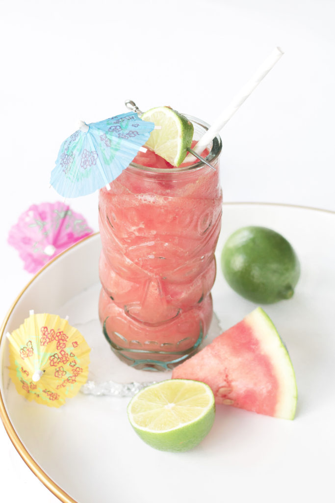 Frozen Water-Yellin’ Watermelon Tiki Drink: pink slushy cocktail in a clear tiki glass