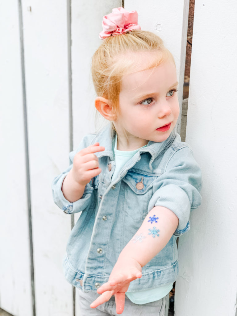 Toddler getting glitter tattoos at Calaway Park