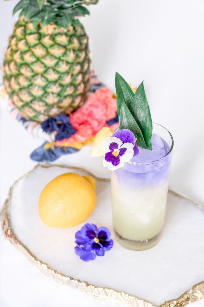 Layered purple and yellow gin pineapple cocktail made with color changing gin 