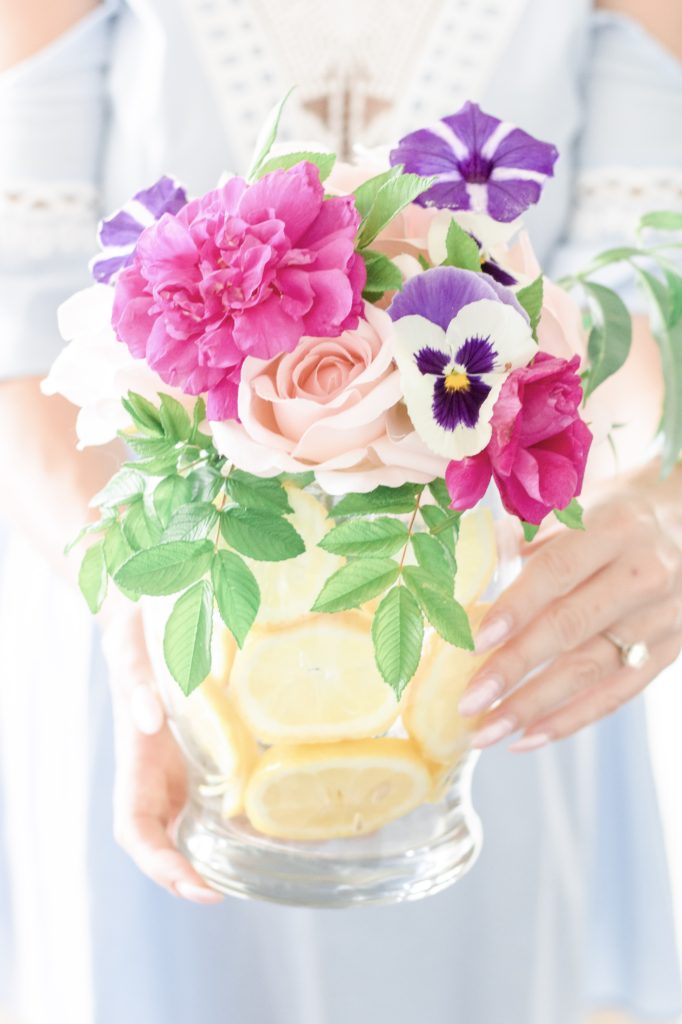 Closeup of fresh floating lemon vase and fresh flower arrangement